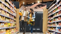A couple in a store with many food packagings and sustainable products A couple in a store with many food packagings and sustainable products