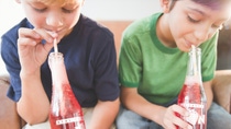 Header image for BASF adhesives: boys drinking soda together, holding glass bottles with transparent labels. Header image for BASF adhesives: boys drinking soda together, holding glass bottles with transparent labels.