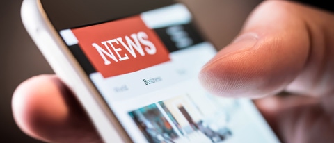 Online news in mobile phone. Close up of smartphone screen. Man reading articles in application. Hand holding smart device. Mockup website. Newspaper and portal on internet.