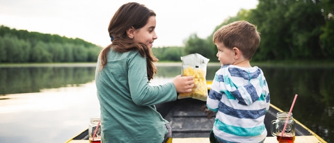 Brother and sister enjoying a boat ride on the river. Brother and sister enjoying a boat ride on the river.