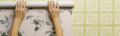 Woman wallpapering wall, close-up