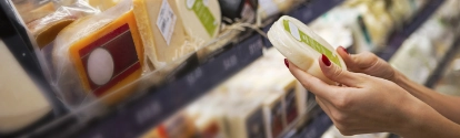 Woman buying cheese ina supermarket