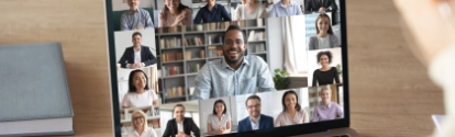 Back view of female employee speak talk on video call with diverse multiracial colleagues on online briefing, woman worker have Webcam group conference with coworkers on modern laptop at home