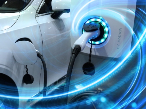 EV Car or Electric vehicle at charging station with the power cable supply plugged in on blurred nature with blue energy power effect. Eco-friendly sustainable energy concept.