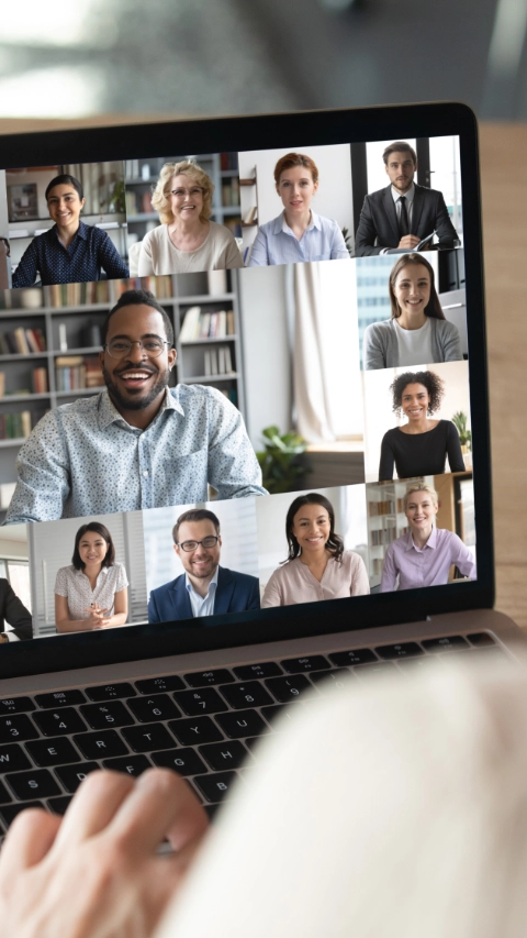 Back view of female employee speak talk on video call with diverse multiracial colleagues on online briefing, woman worker have Webcam group conference with coworkers on modern laptop at home