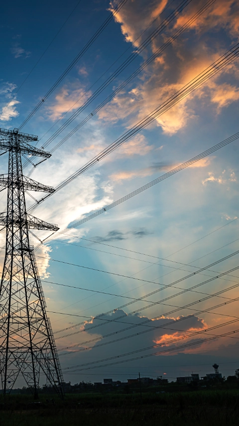 Electricity Pylon power line transmission tower at sunset